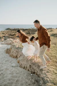 des parents s'amusent avec leur fille sur le plage de Locmariaquer photographe morbihan