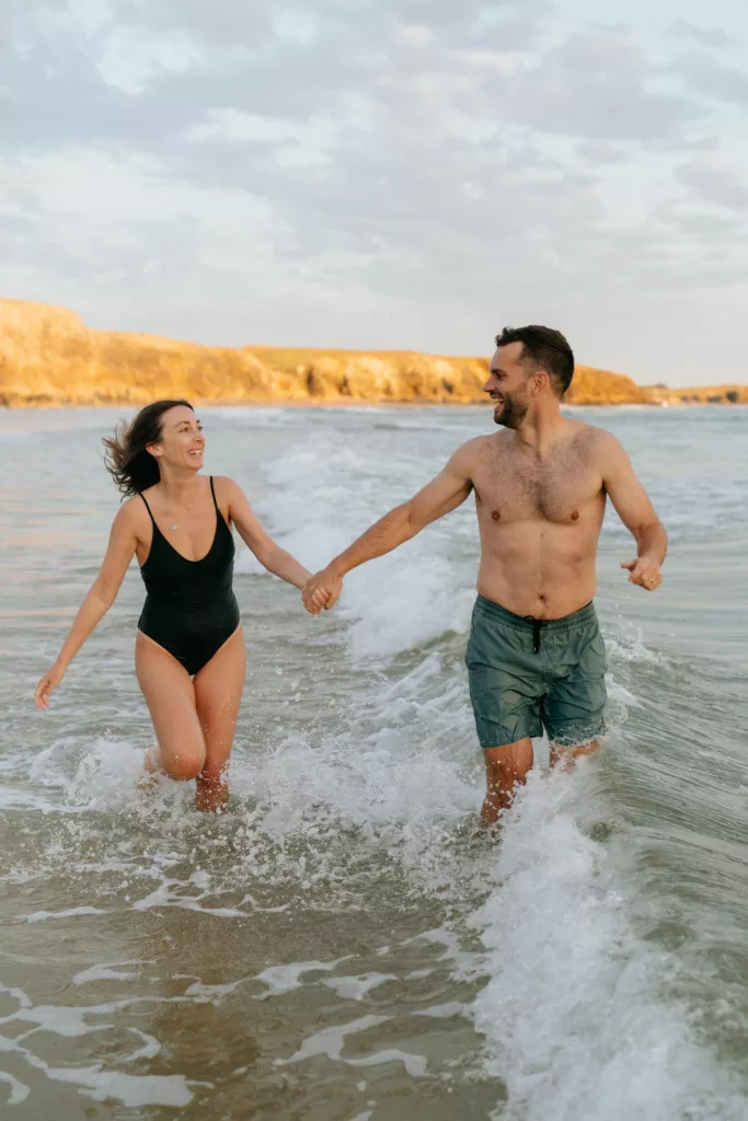 Couple s'amusant avec les vagues séance photo été